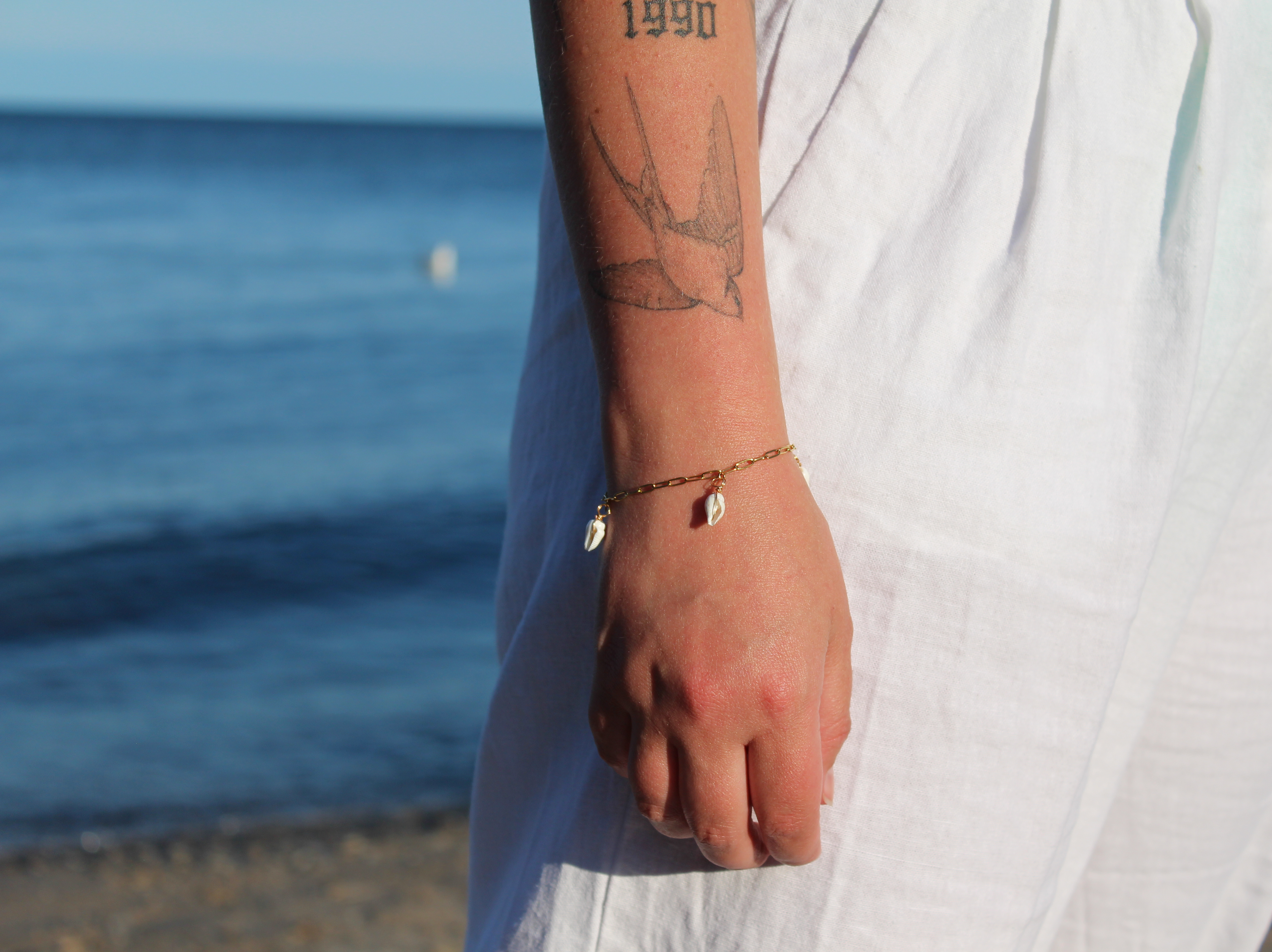 18K gold-plated waterproof tarnish-free paperclip chain bracelet with 3 mini seashells, handmade and woman owned by CHRMD.
