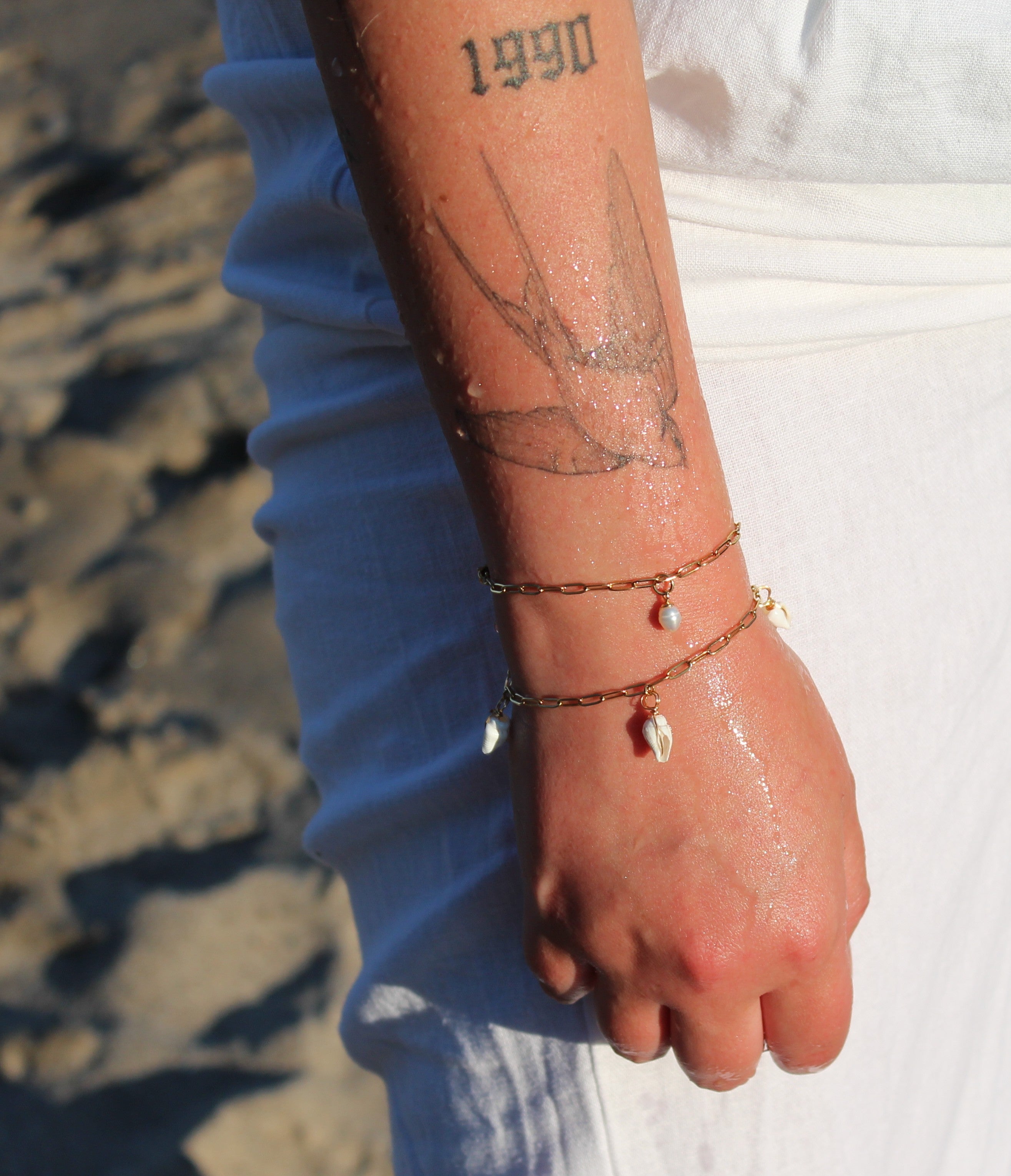 18K gold-plated waterproof tarnish-free paperclip chain bracelets, one with a single pearl, one with 3 mini seashells, handmade and woman owned by CHRMD.